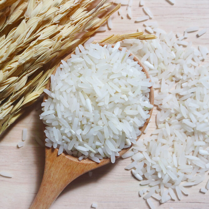 Rice,In,Wooden,Spoon,And,Paddy,On,Wooden,Background